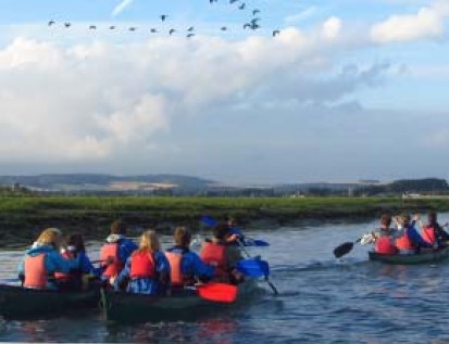School group paddling across beautiful Chichester Harbour
